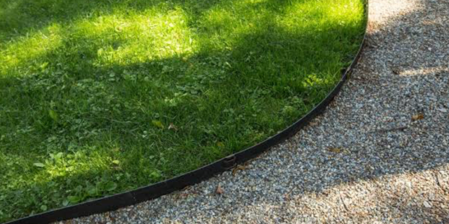 clean lawn edging border separating green grass from gravel pathway