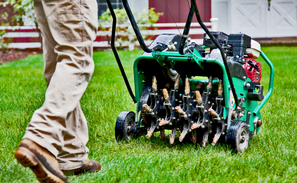 lawn aerator machine improving soil and grass health in a backyard lawn