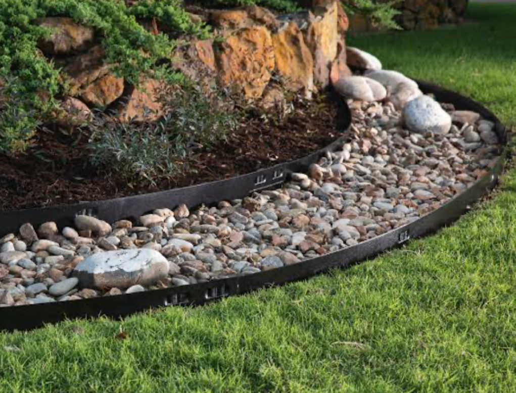 wooden garden edging fence around flower bed near house landscaping