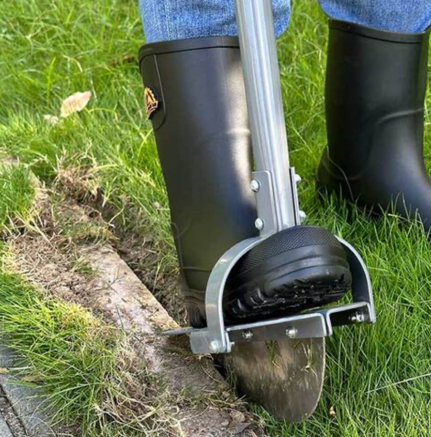 using string trimmer for lawn edging along garden border for clean lines