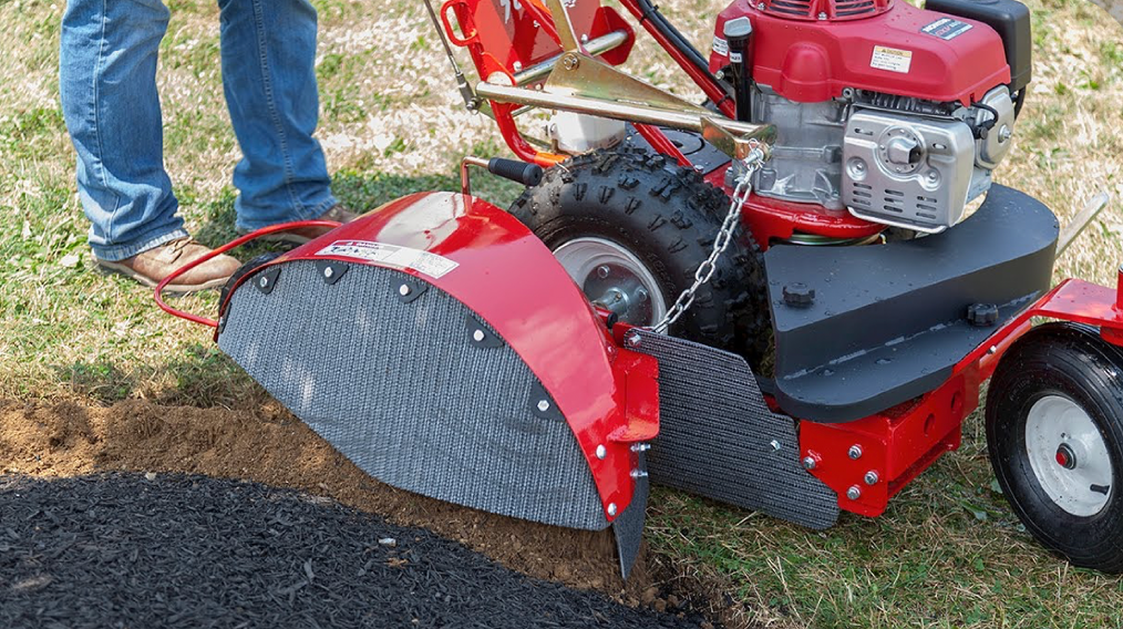 manual lawn edger tool cutting clean edge between grass and soil border