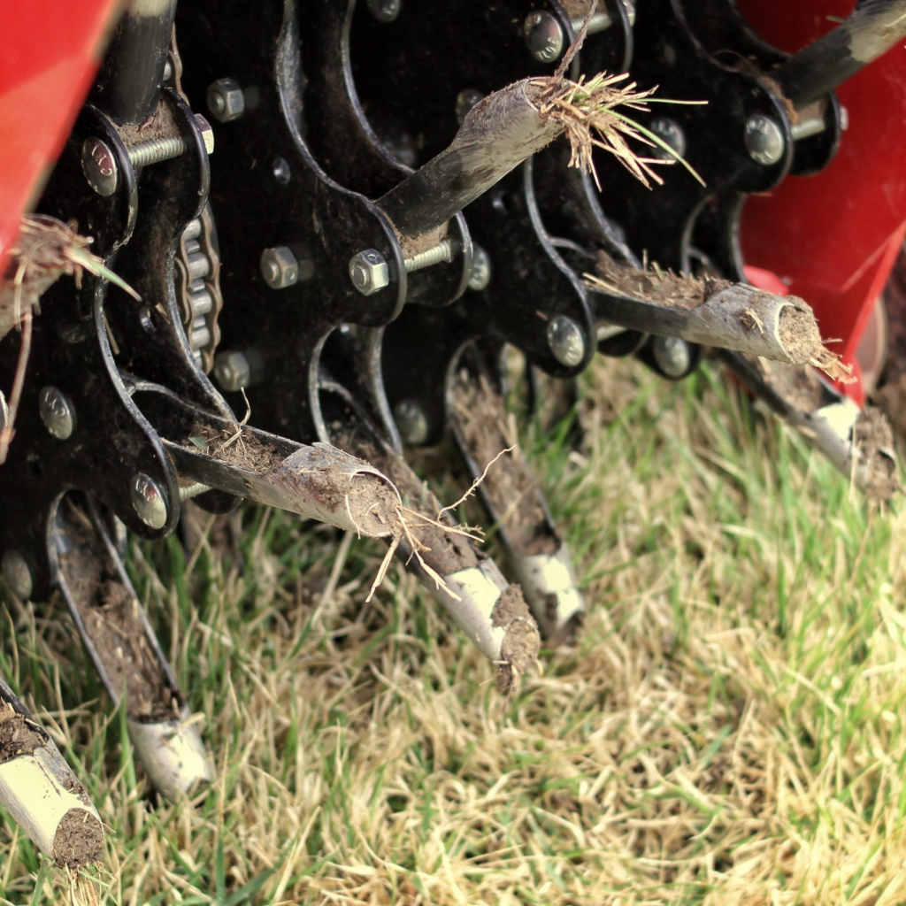 core aerator machine removing soil plugs to improve lawn health and root growth