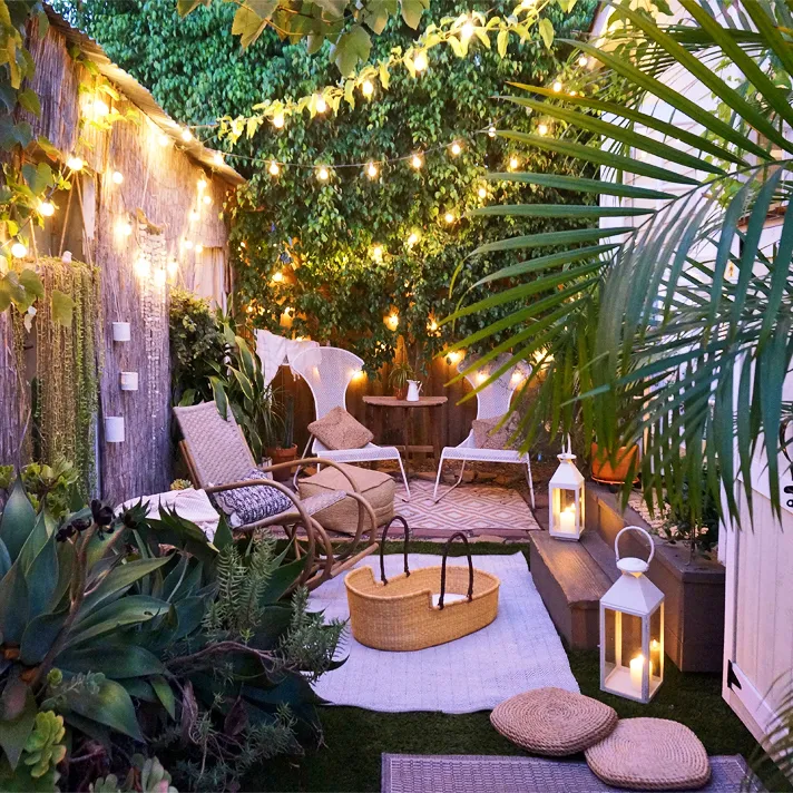 A small garden with overhead lighting.