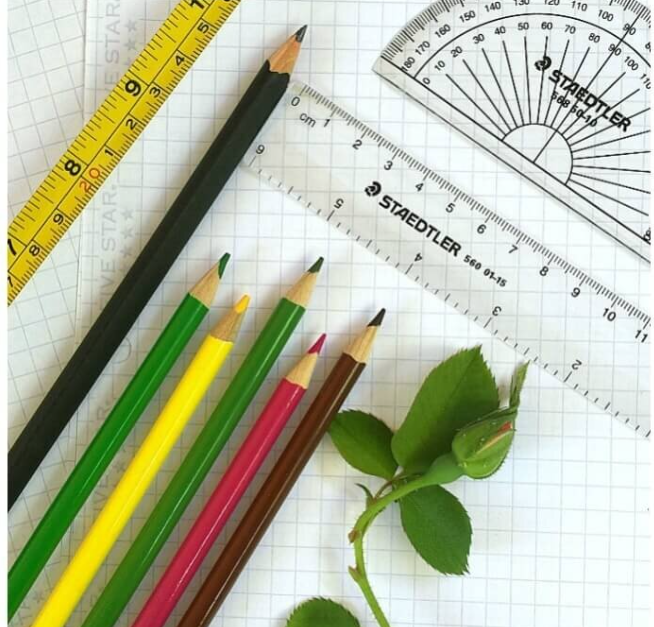 Drawing tools laid out on graph paper.