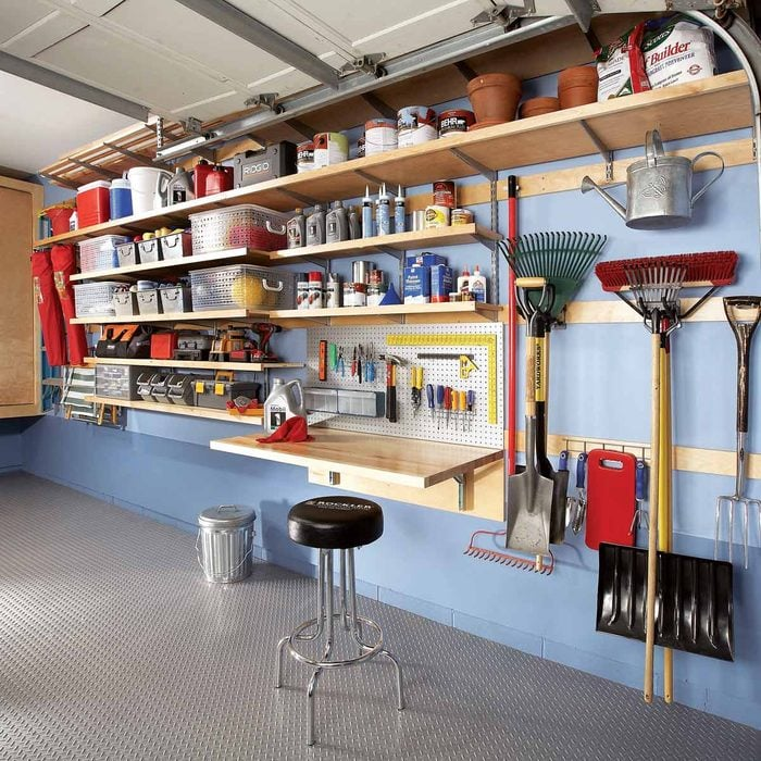 A garage with storage racks affixed to its wall.