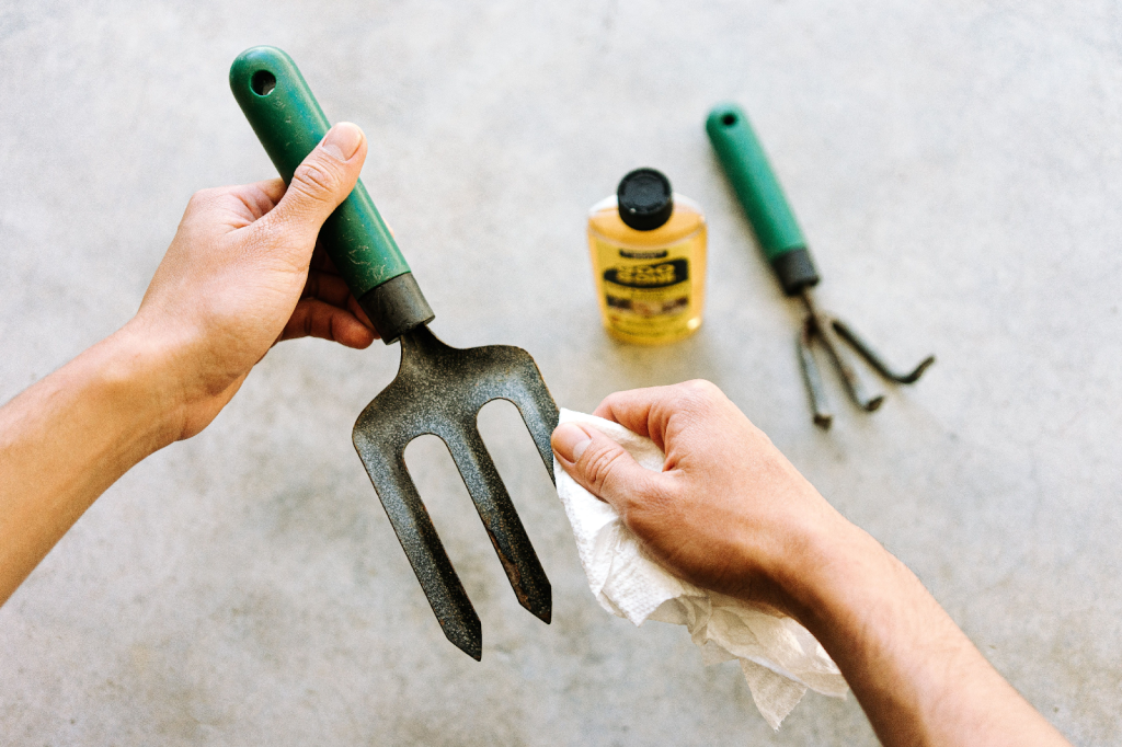 A gardener caring for their hand tools