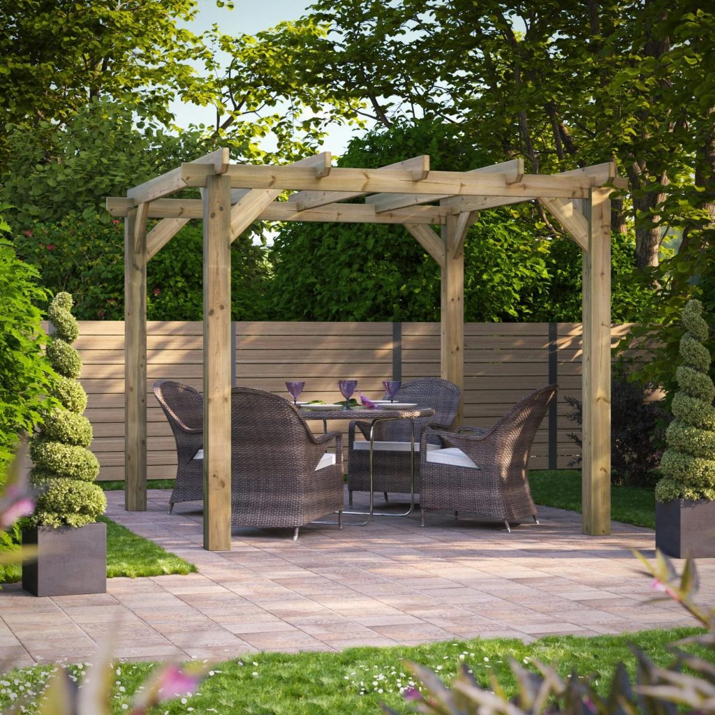 Wooden pergola with outdoor dining furniture set up on a stone patio in a backyard garden