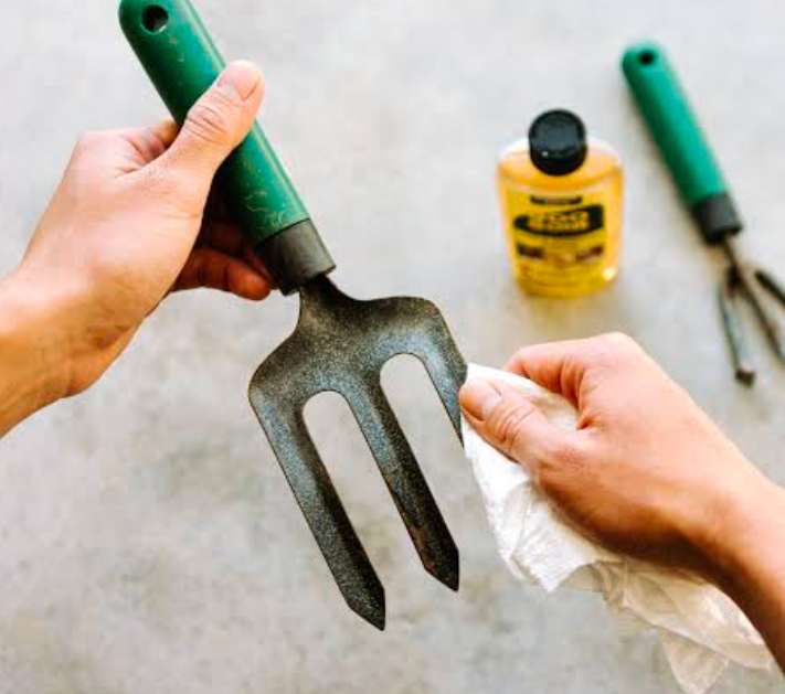 Gardening tool being cleaned by hand.