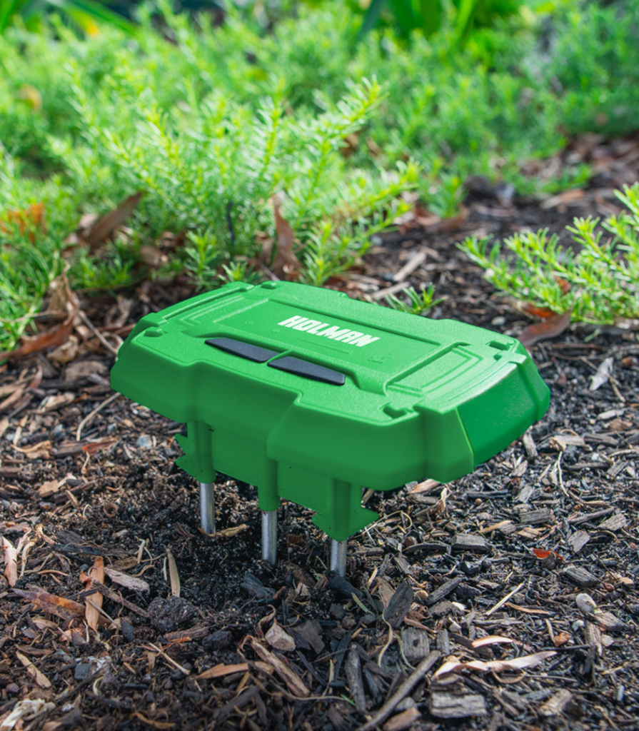Holman soil moisture sensor with three probes monitoring garden soil.
