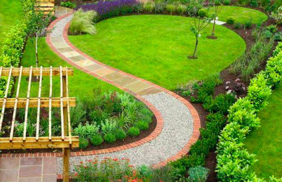 Curving garden path with brick edging, gravel walkway, and manicured lawn.