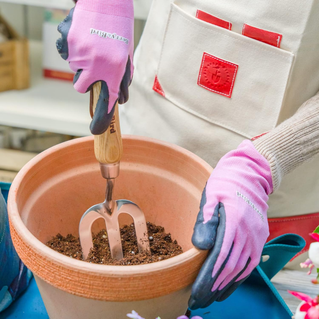 Berry&Bird Ergonomic Gardening Hand Fork being used in a terracotta pot.