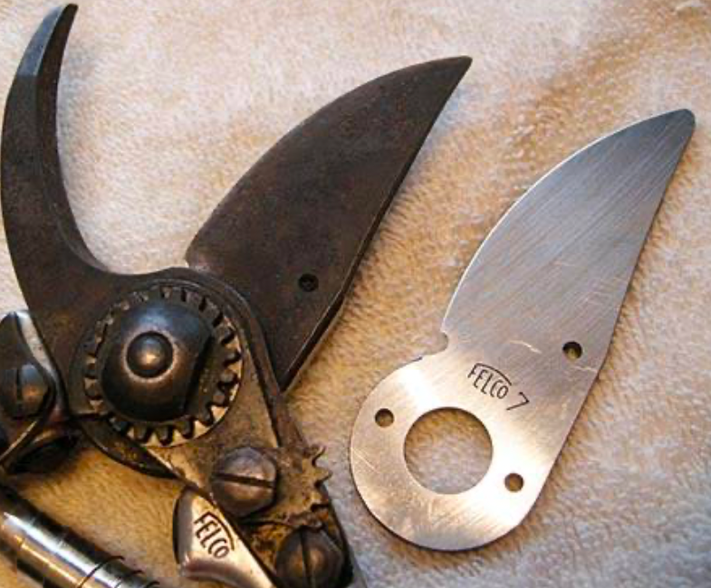 A shiny new blade next to the attached worn blades in need of a replacement.
