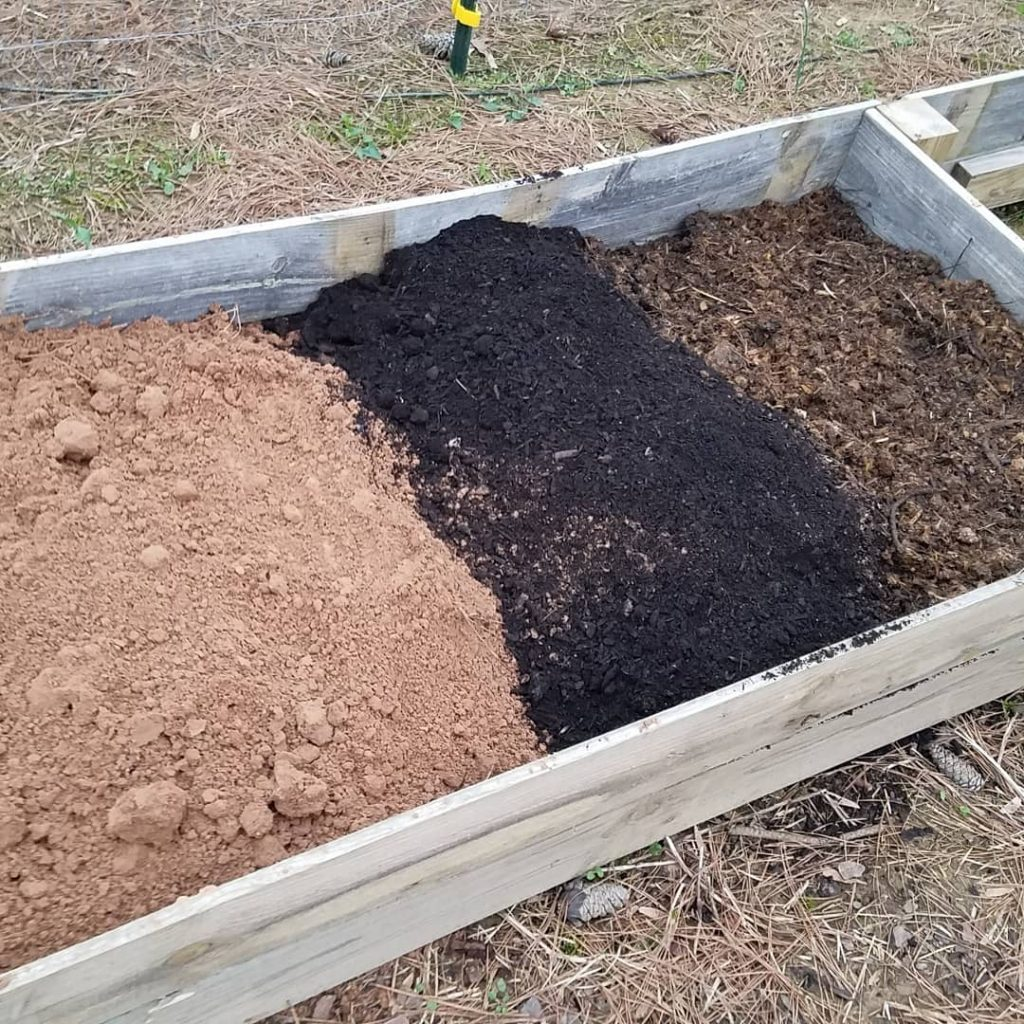 Sail being prepped in a raised bed.