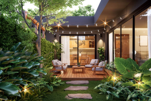 Modern contemporary style small wooden terrace in lush garden.