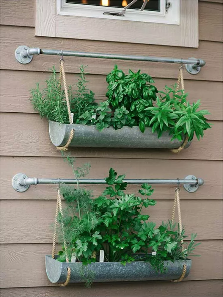 A creative metal planter affixed to a buildings siding.