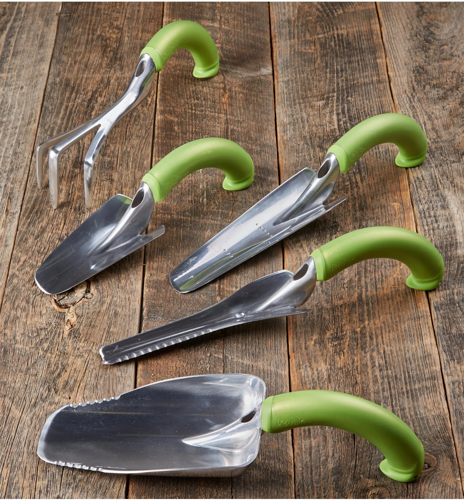A ergonomic set of green handled curved gardening tools
