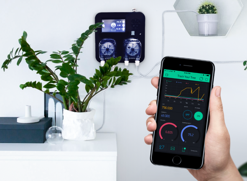 A hand holding a phone with an app showing an app tracking a plants metrics.