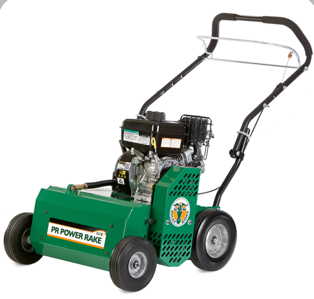 Electric lawn dethatcher and scarifier machine on green grass with collection bag attached